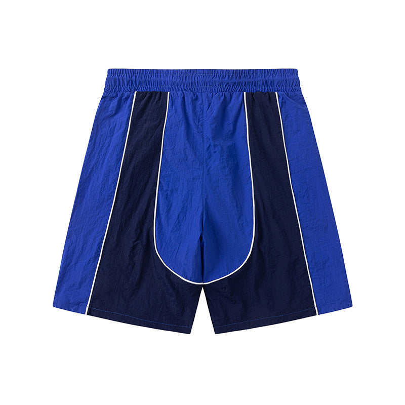 Blue and khaki drawstring casual shorts with elastic waist, side pockets, contrast piping, and small leg emblem - view 1