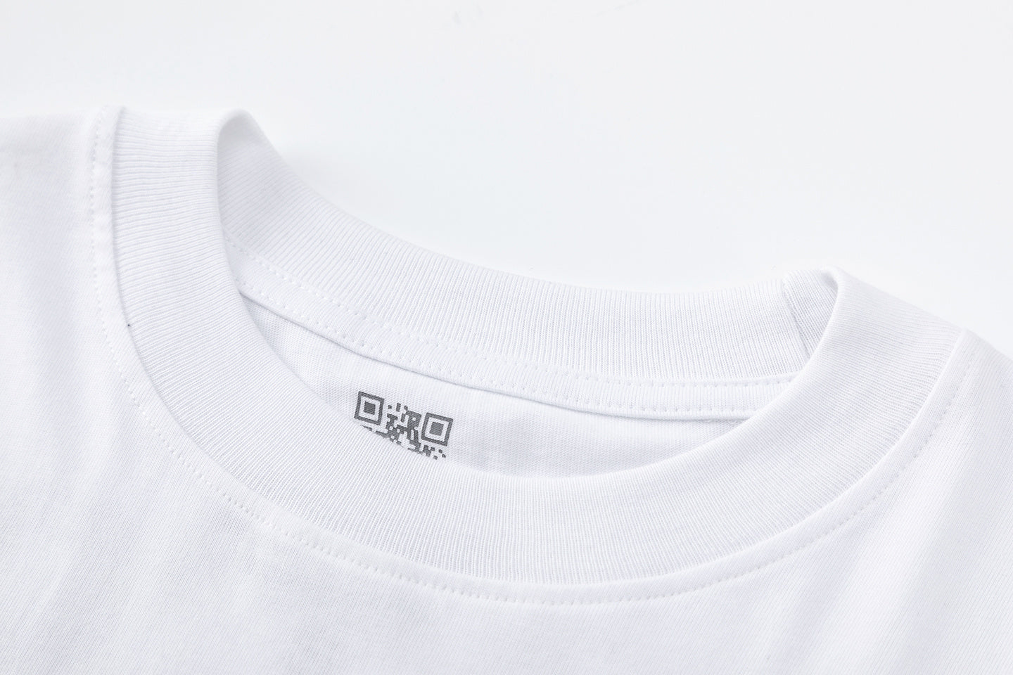 White unisex oversized graphic T-shirt with red front emblem and bold black back text - view 2