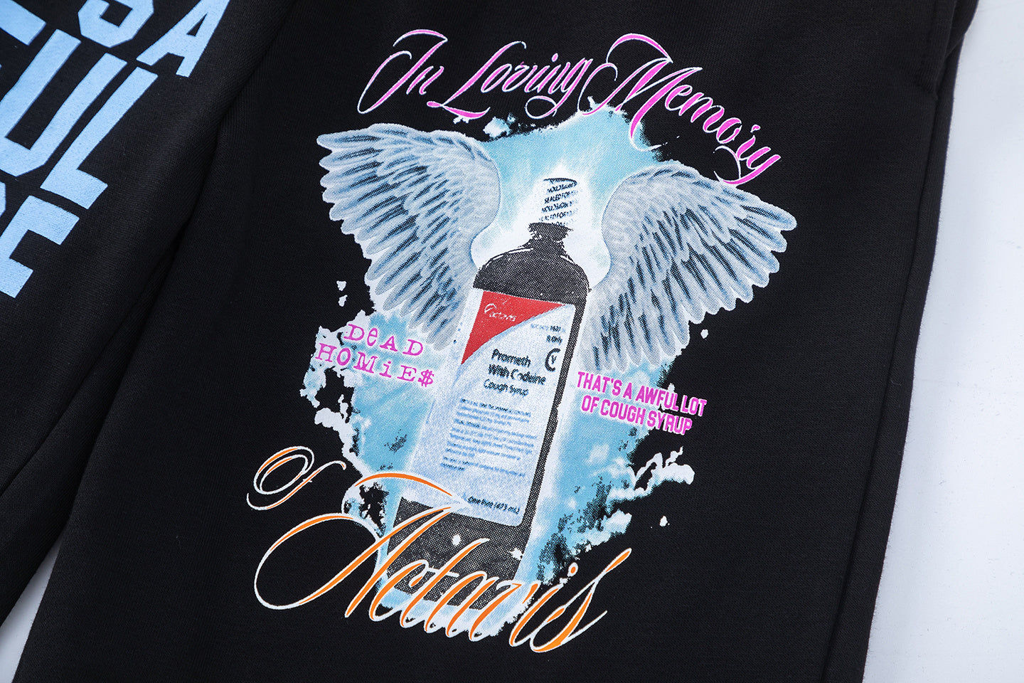 Men's black graphic shorts with light blue lettering, bottle-and-wings print, drawstring waist, and rear patch pocke - view 3