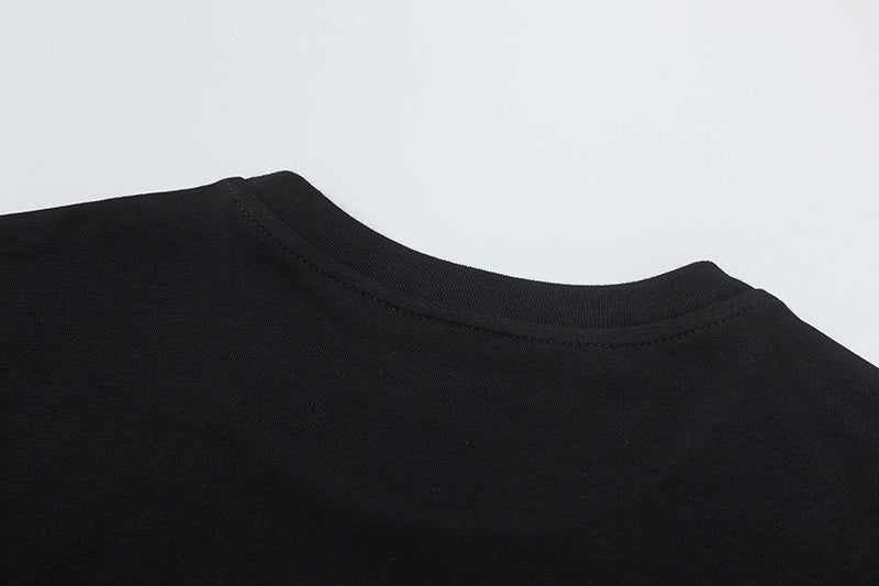 Black crewneck short sleeve T-shirt with yellow text graphic and white graffiti-style chest artwork - view 3