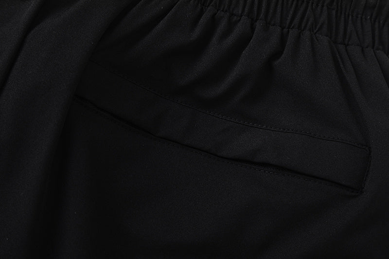 Black unisex drawstring shorts with blue letter graphic, elastic waistband, and side pockets - view 5