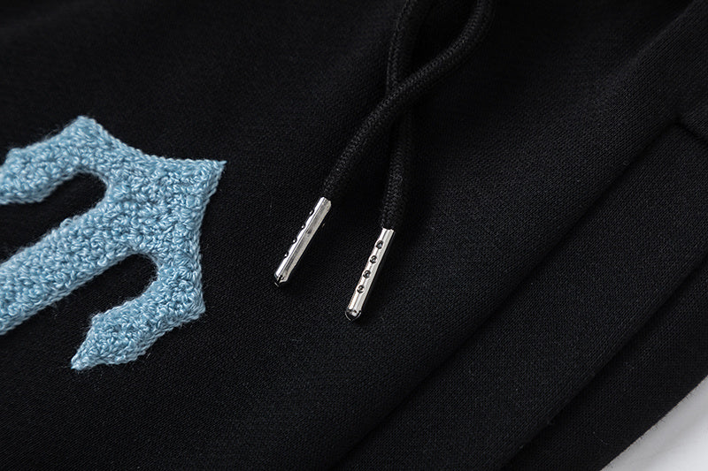 Black Trapstar graphic pullover hoodie and jogger pants two-piece tracksuit set with blue, white and gray lettering - view 6