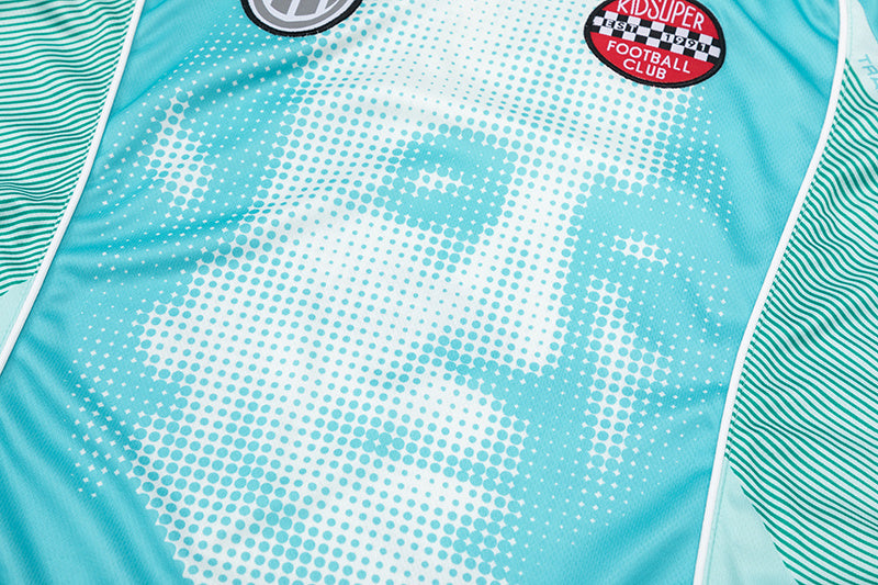 Turquoise Trapstar graphic football jersey with KidSuper Studios artwork and contrast striped panels - view 9