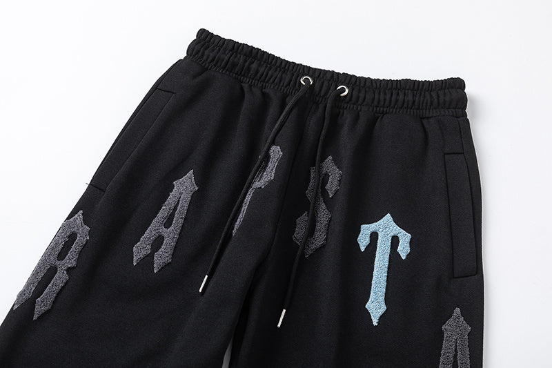 Black Trapstar graphic pullover hoodie and jogger pants two-piece tracksuit set with blue, white and gray lettering - view 10