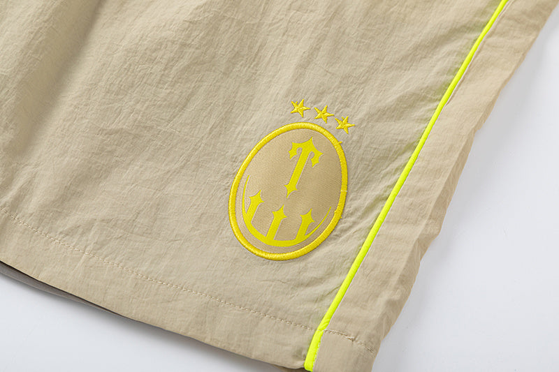 Blue and khaki drawstring casual shorts with elastic waist, side pockets, contrast piping, and small leg emblem - view 10