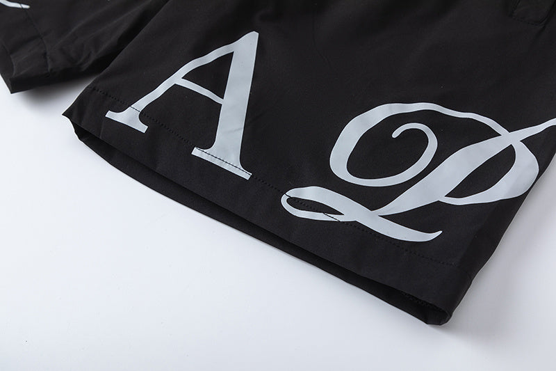 Black unisex drawstring shorts with blue letter graphic, elastic waistband, and side pockets - view 12
