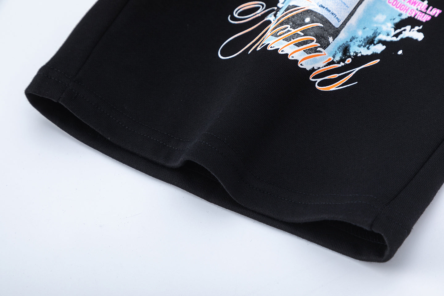 Men's black graphic shorts with light blue lettering, bottle-and-wings print, drawstring waist, and rear patch pock - view 13