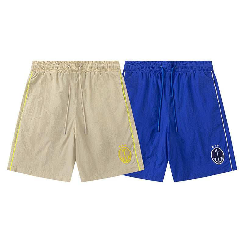 Blue and khaki drawstring casual shorts with elastic waist, side pockets, contrast piping, and small leg emblem - view 14