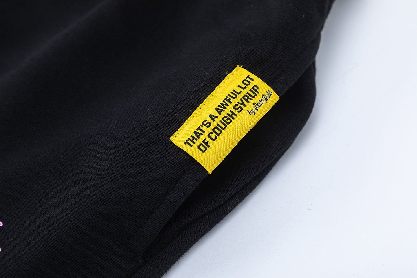 Men's black graphic shorts with light blue lettering, bottle-and-wings print, drawstring waist, and rear patch pock - view 14