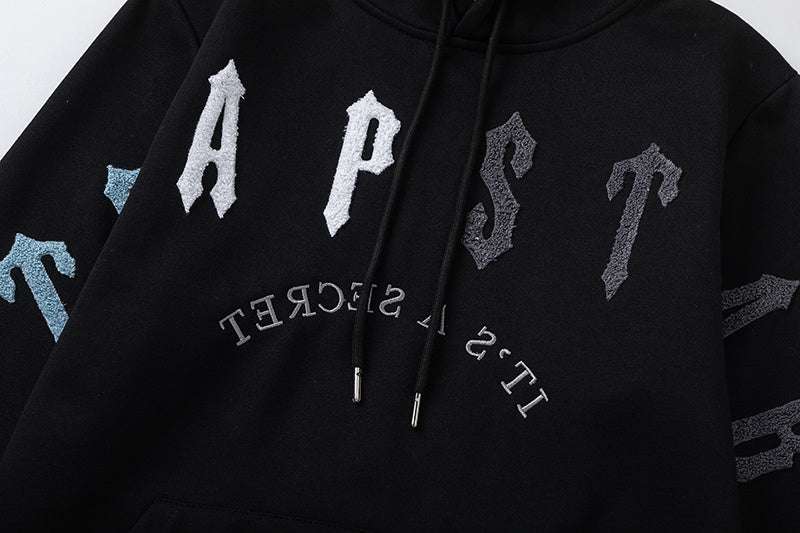 Black Trapstar graphic pullover hoodie and jogger pants two-piece tracksuit set with blue, white and gray lettering - view 20