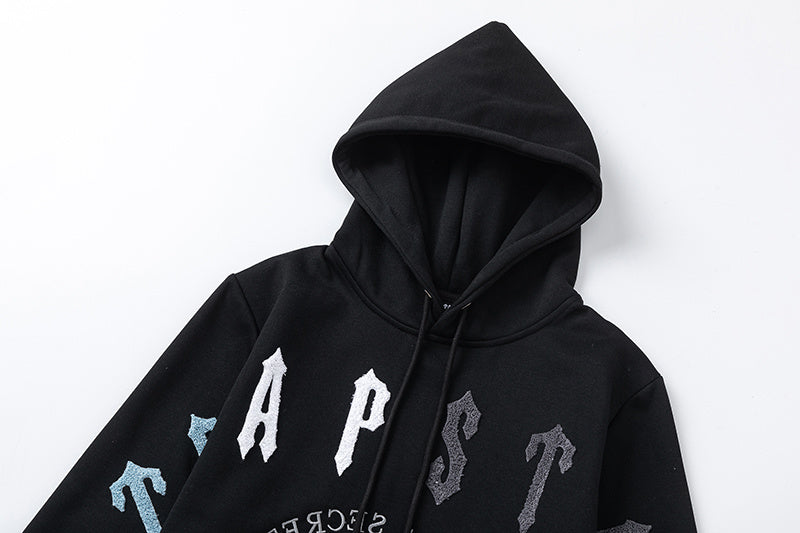 Black Trapstar graphic pullover hoodie and jogger pants two-piece tracksuit set with blue, white and gray lettering - view 22